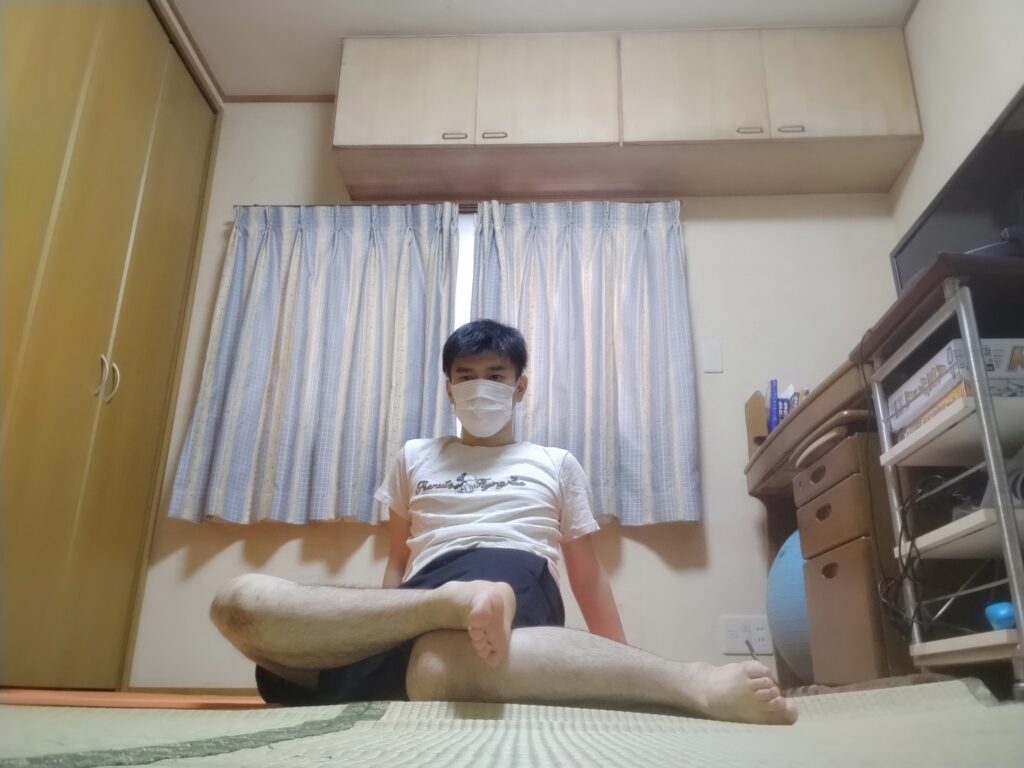 安楽座で背筋を伸ばして座る男性のヨガポーズ